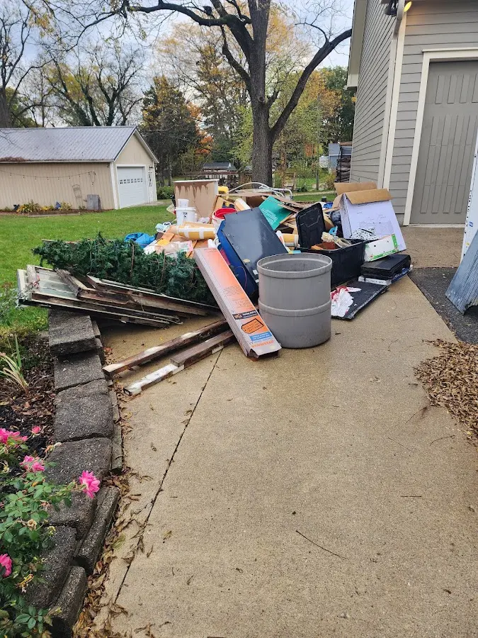 Dumpster being loaded with debris for 30 Yard Dumpster Rental in Sterling Heights